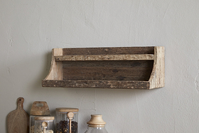 The nkuku Ibo Reclaimed Wood Storage Shelf - Natural adds rustic charm, mounted above a countertop with glass jars, a wooden cutting board, and a ceramic container—ideal for stylish kitchen storage.