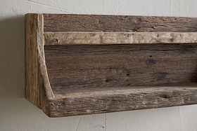 The nkuku Ibo Reclaimed Wood Storage Shelf - Natural adds charm and extra kitchen storage to any wall with its rustic, wall-hung design made from weathered wood.
