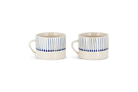 The nkuku Iba Mug - Indigo - Large (Set of 2) features hand-painted, cream-colored ceramics with vertical blue lines and dots on the upper half, showcasing a simple modern design. Both mugs have handles and are displayed against a plain white background.