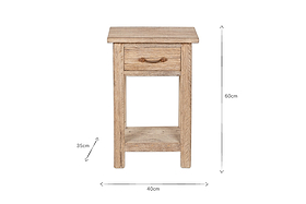The Ibo Reclaimed Wood Bedside Table - Natural by nkuku is a rustic bedside table crafted from reclaimed wood, featuring one drawer with a dark metal pull, an open shelf below, and measures 60cm H x 40cm W x 35cm D.