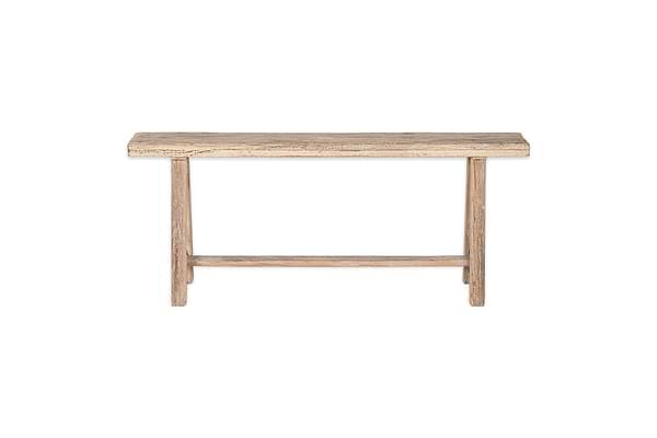 The nkuku Ibo Reclaimed Wood Long Bench - Natural has a rectangular seat, straight legs, and a support bar, all in a rustic natural finish. It’s shown on a plain white background for a clean, timeless look.