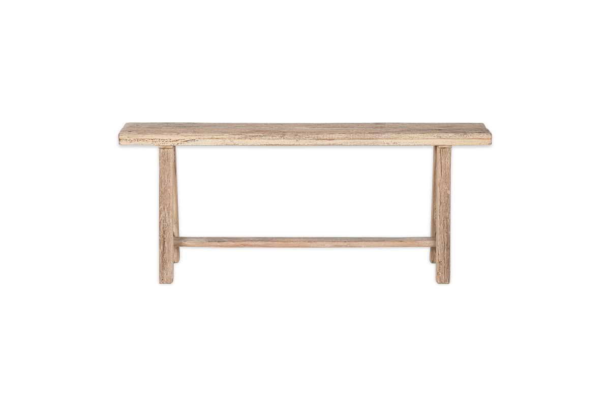 The nkuku Ibo Reclaimed Wood Long Bench - Natural has a rectangular seat, straight legs, and a support bar, all in a rustic natural finish. It’s shown on a plain white background for a clean, timeless look.
