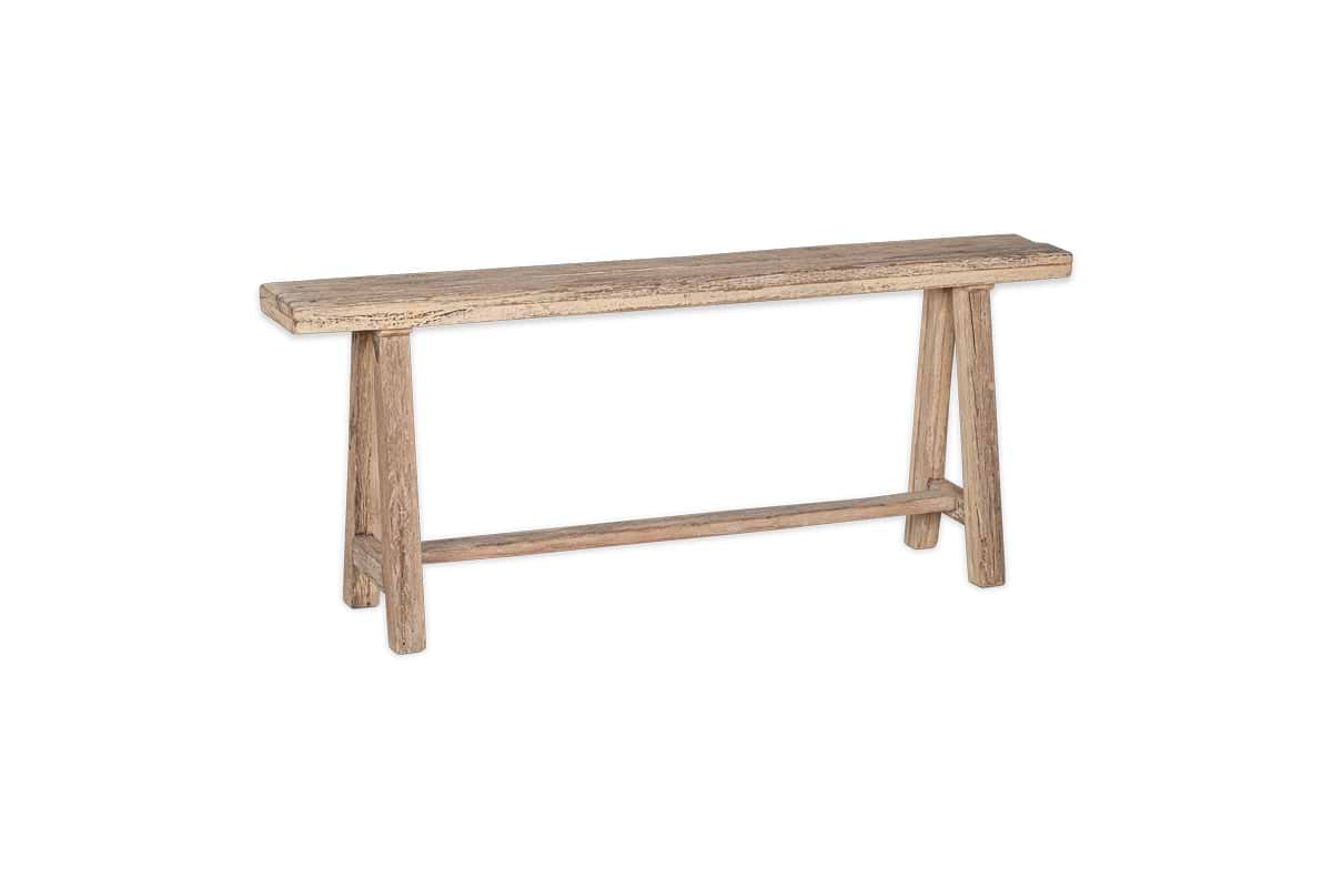 The nkuku Ibo Reclaimed Wood Long Bench - Natural features a simple rectangular seat and angled legs with a support bar, all crafted from light reclaimed wood with a natural finish. Displayed on a white background.