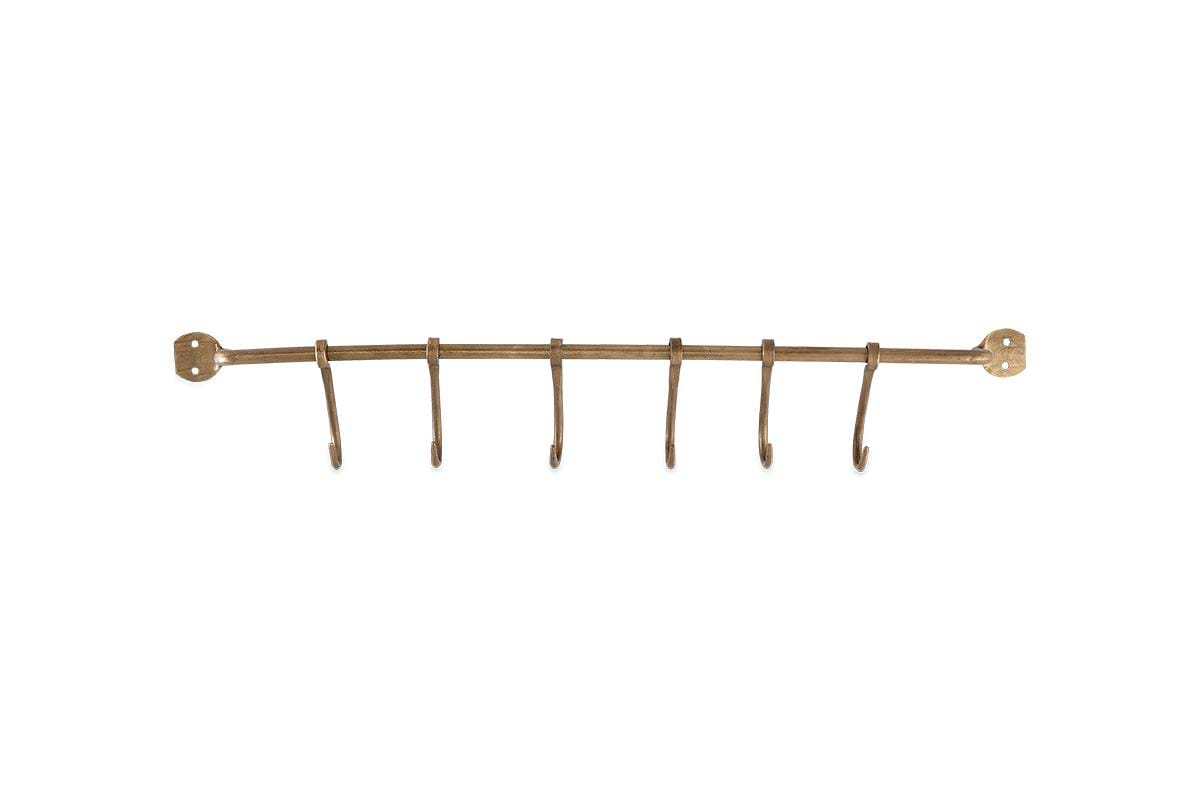 The Ikoma Hook Set by nkuku is a wall-mounted, antique brass metal rack with six evenly spaced hooks and two mounting plates, providing stylish and functional hanging storage.