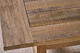 Close-up of the nkuku Indali Mango Wood Dining Table - Natural, featuring a rectangular inlay design. The visible grain and natural imperfections add character, perfect for small spaces and highlighted by lighting on a light woven rug.