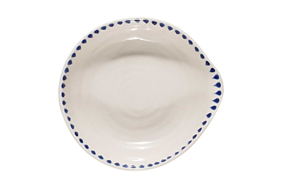 The Indigo Drop Spoon Rest - Cream & Indigo by nkuku is a handcrafted, round ceramic plate with a handle-like detail. Its cream surface is accented by blue teardrop motifs around the rim, offering a simple yet elegant spot for your spoon. Photographed from above.