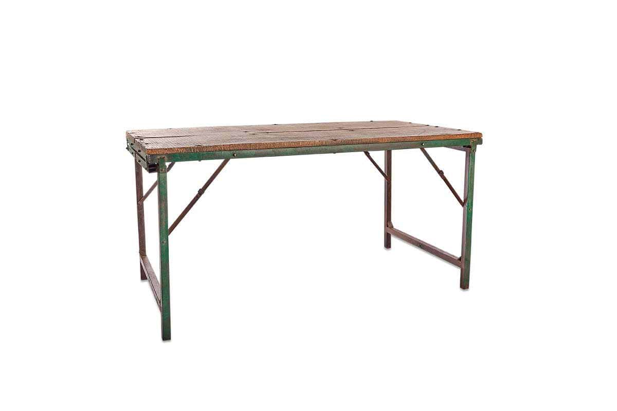 The Ishan Reclaimed Folding Dining & Coffee Table by nkuku features a weathered wooden top with visible screws and green metal legs showing rust, highlighting its vintage charm against a simple white background.