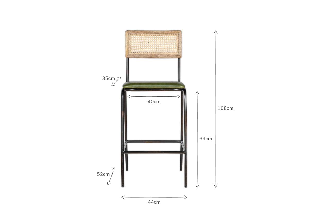 Front view of the Iswa Leather & Cane Counter Chair by nkuku, showcasing a woven cane back, rich green leather seat, and black metal frame. Dimensions: 108cm H, 44cm W, 40cm seat W, 35cm backrest H, 69cm seat H, 52cm leg H.