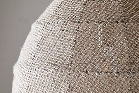 Close-up of the nkuku Jahari Woven Jute Pendant in Natural, featuring a dome-shaped design with coarse, woven burlap for visible texture—ideal for adding rustic charm to any home decor.