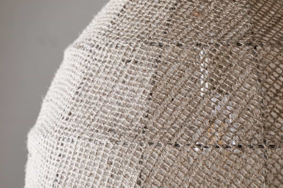 Close-up of the nkuku Jahari Woven Jute Pendant in Natural, featuring a dome-shaped design with coarse, woven burlap for visible texture—ideal for adding rustic charm to any home decor.