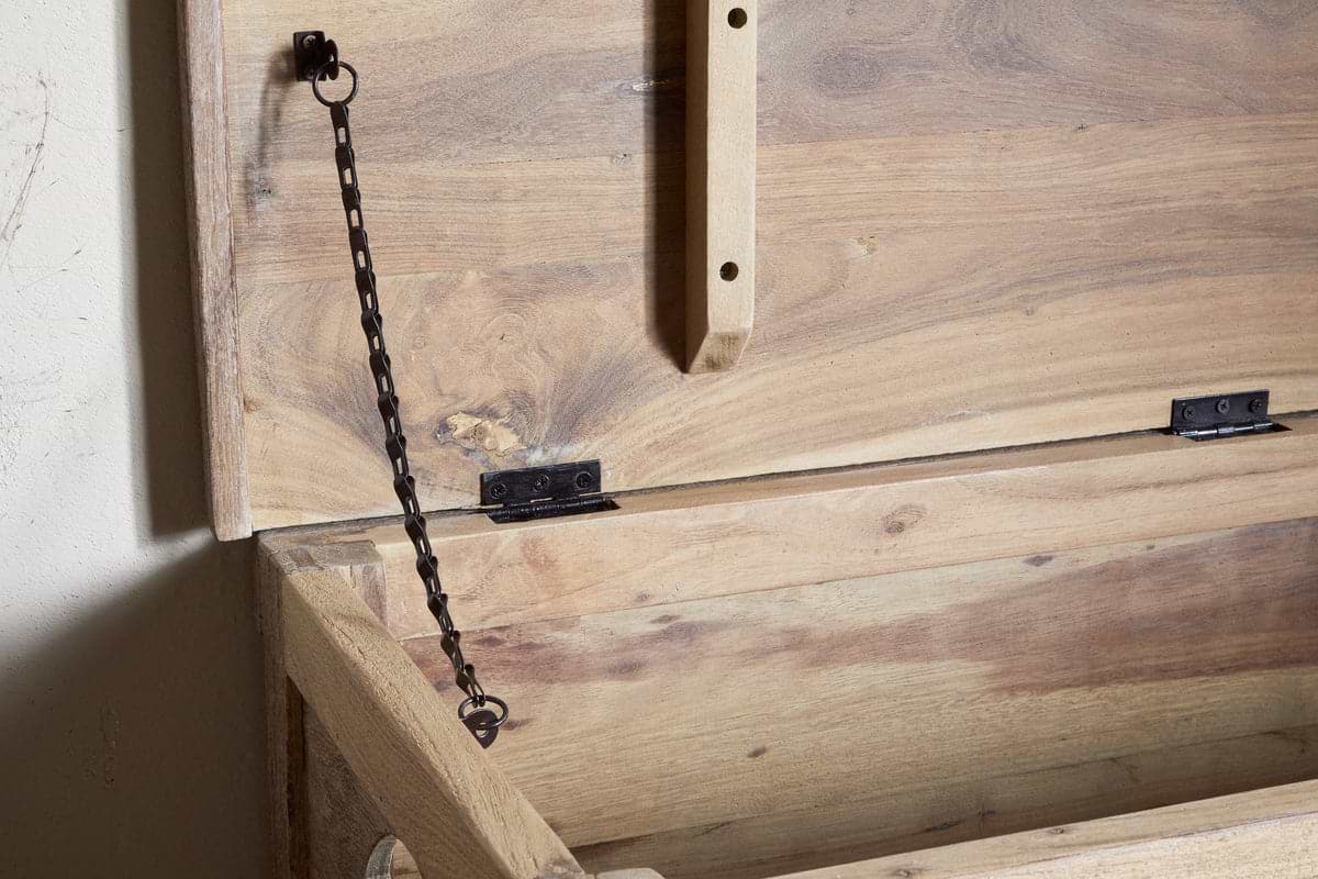 The Karadi Reclaimed Wood Storage Bench - Natural by nkuku features an open, unfinished wooden chest with a hinged lid supported by a black metal chain, making it an ideal rustic storage bench for any space.
