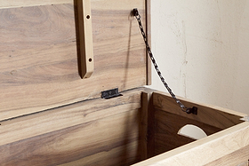 The Karadi Reclaimed Wood Storage Bench by nkuku features sturdy chains and natural wood—ideal as a hallway bench or stylish storage solution for your home.