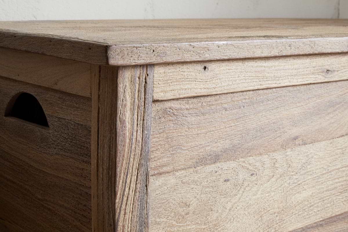 Close-up of the nkuku Karadi Reclaimed Wood Storage Bench in a natural finish, featuring a flat lid, cut-out side handle, and timeless rustic design—perfect as a functional hallway bench.