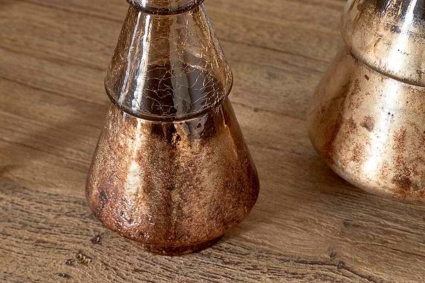 The Konara Glass Tree by nkuku features a gold crackle finish, creating a striking accent piece. Its metallic sheen and unique texture make it perfect for adding festive charm to any space or table setting.