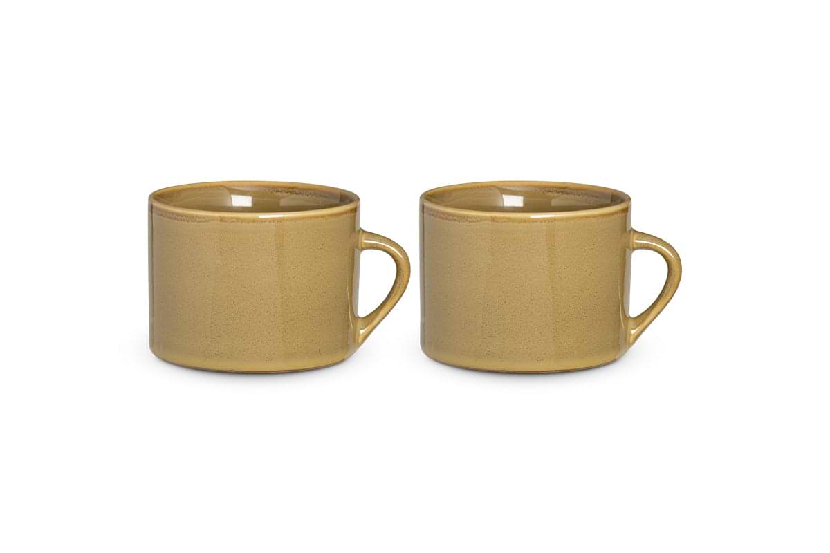 A set of two large green Kalini mugs by nkuku, with round bodies and curved handles, sits side by side on a white background. These kiln-fired mugs have a glossy, minimalistic finish with no visible patterns or decorations.