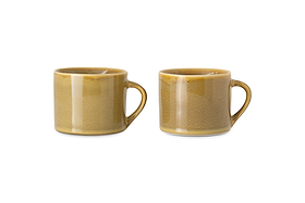 The nkuku Kalini Mugs - Green - Small (Set of 2) feature rounded bodies, large handles, and a glossy, slightly speckled finish. Shown side by side against a white background, these handmade mugs are beautifully crafted.