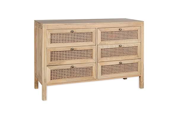 The Kanz Mango Wood Chest Of Drawers by nkuku features six drawers with woven cane panels and round metal knobs, all in solid natural mango wood. Its rectangular frame stands on straight legs for a minimalist, rustic look.