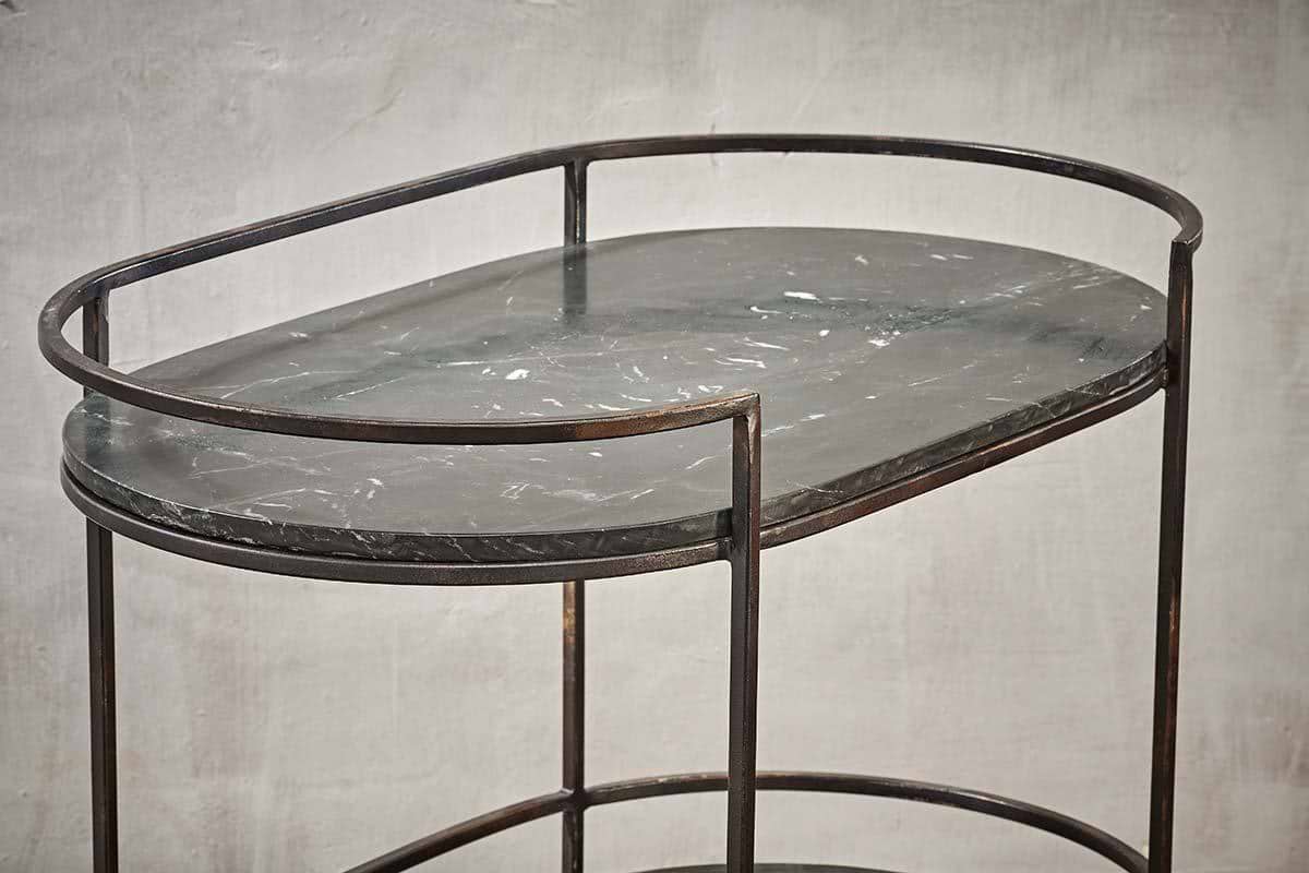 The Karoko Marble Drinks Table by nkuku features an oval black marble top with white veining, slim black metal legs, and a matching rim—a minimalist standout for entertaining in modern spaces.