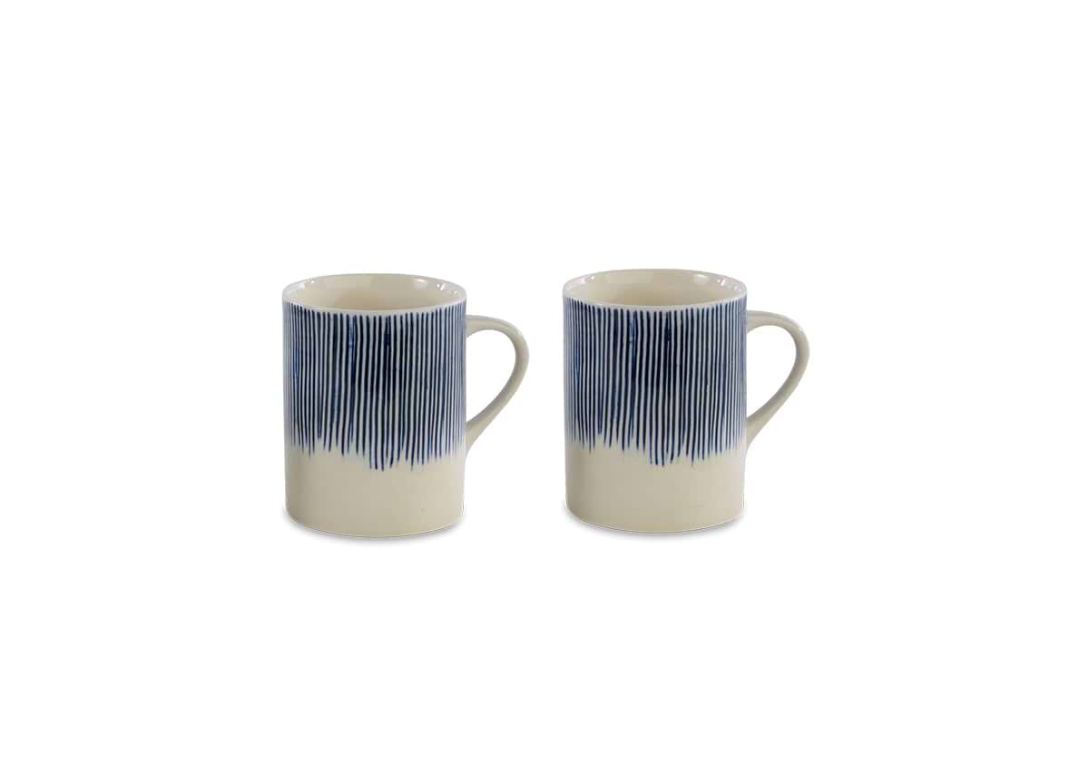 The nkuku Karuma Ceramic Mug - Large (Set of 2) features handmade mugs with handles and a vertical blue stripe design fading into a cream base, displayed on a plain white background.