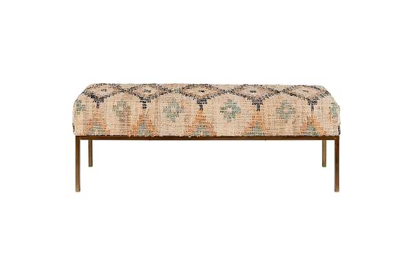The Kesu Kilim & Iron Bench by nkuku features a handloom-woven seat in muted earth-toned patterns atop slim, bronze-finished iron legs for a minimalist look. Geometric designs on fabric; photographed against a plain white background.