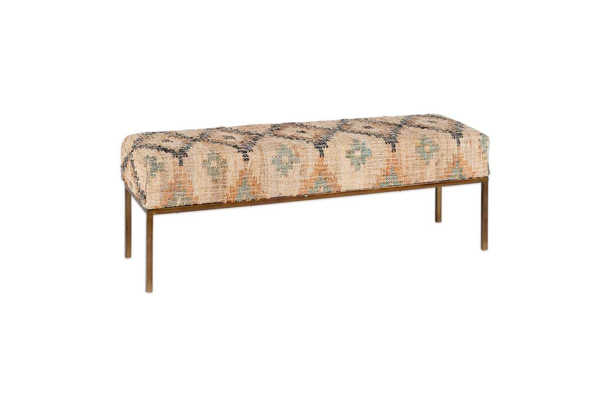 The Kesu Kilim & Iron Bench by nkuku features a rectangular seat upholstered in peach, teal, and black kilim-style fabric with geometric patterns, set on a slim iron frame with four straight legs.