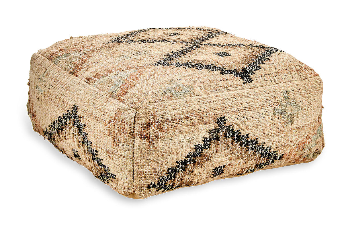 The nkuku Kesu Kilim Pouf - Large is a square, flat pouf with textured beige fabric. Its black, gray, and brown geometric patterns lend a rustic Southwestern vibe—ideal for extra seating or as a cozy footrest.