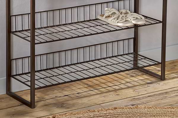 The nkuku Kiyoma Iron & Wood Tall Standing Shelves - Natural features three metal and wood shelves against a light wall. Braided rope slippers sit neatly on the top shelf, while the bottom shelf remains empty, lending an industrial touch to the space.