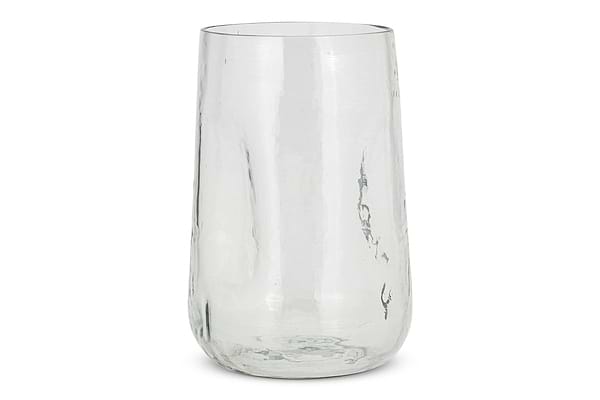 The Kotri Recycled Glass Organic Shape Vase by nkuku stands upright against a white background. Made from clear, hand-hammered glass, its smooth surface and gentle imperfections highlight its artisanal quality.