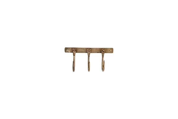 The nkuku Kuna Iron Hooks - Antique Brass features three vintage, curved iron hooks on a rectangular wall-mounted base with two visible screw holes, ideal for adding stylish, small storage to any space.