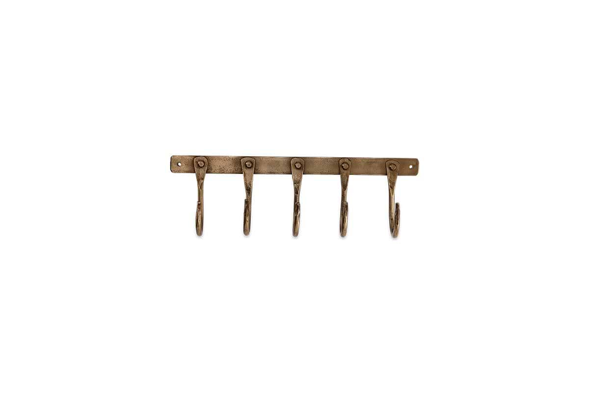 The nkuku Kuna Iron Hooks in antique brass offer five wall-mounted hooks with rounded ends for compact storage. An industrial vintage look is highlighted by a sturdy bar and end screw holes for secure mounting.