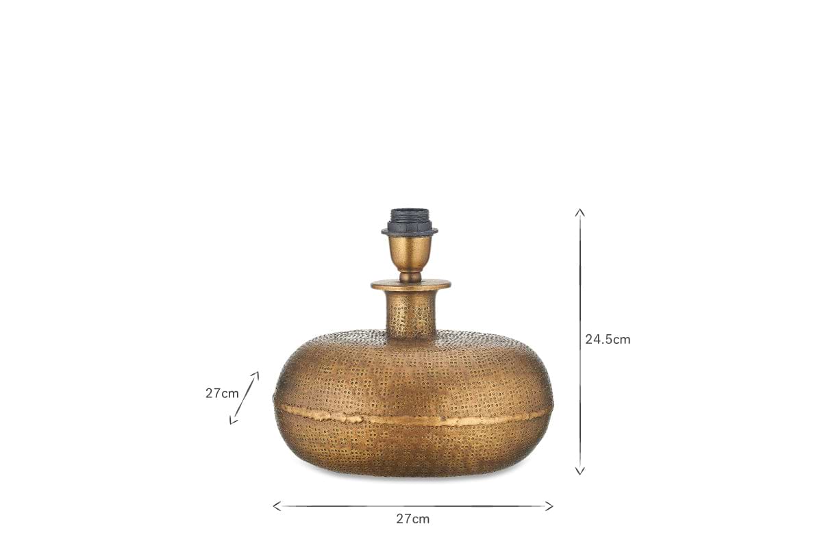 The nkuku Lumbu Lamp - Antique Brass (Small) features a round, textured artisan base with central neck and bulb holder. Dimensions: 27cm W x 27cm D x 24.5cm H. Shown on a white background with black arrows for size—ideal for decorative lighting.