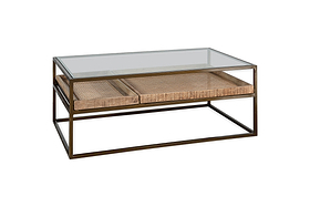 The nkuku Luzon Iron & Mango Wood Display Coffee Table - Brass features a minimalist design with a sleek metal frame, glass top, and two woven rattan drawers, combining transparency, texture, and a stylish brass finish.
