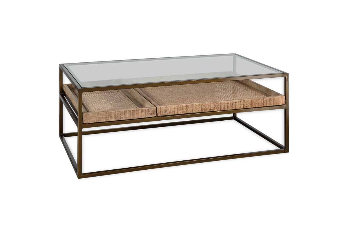 The nkuku Luzon Iron & Mango Wood Display Coffee Table - Brass features a minimalist design with a sleek metal frame, glass top, and two woven rattan drawers, combining transparency, texture, and a stylish brass finish.