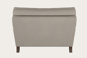 The Marri Love Seat - Brera Linen Natural by Nkuku is shown from the back, handcrafted in a light beige linen with a smooth, cushioned backrest, clean lines, and dark wooden legs. A plain off-white background highlights its simple, modern design.