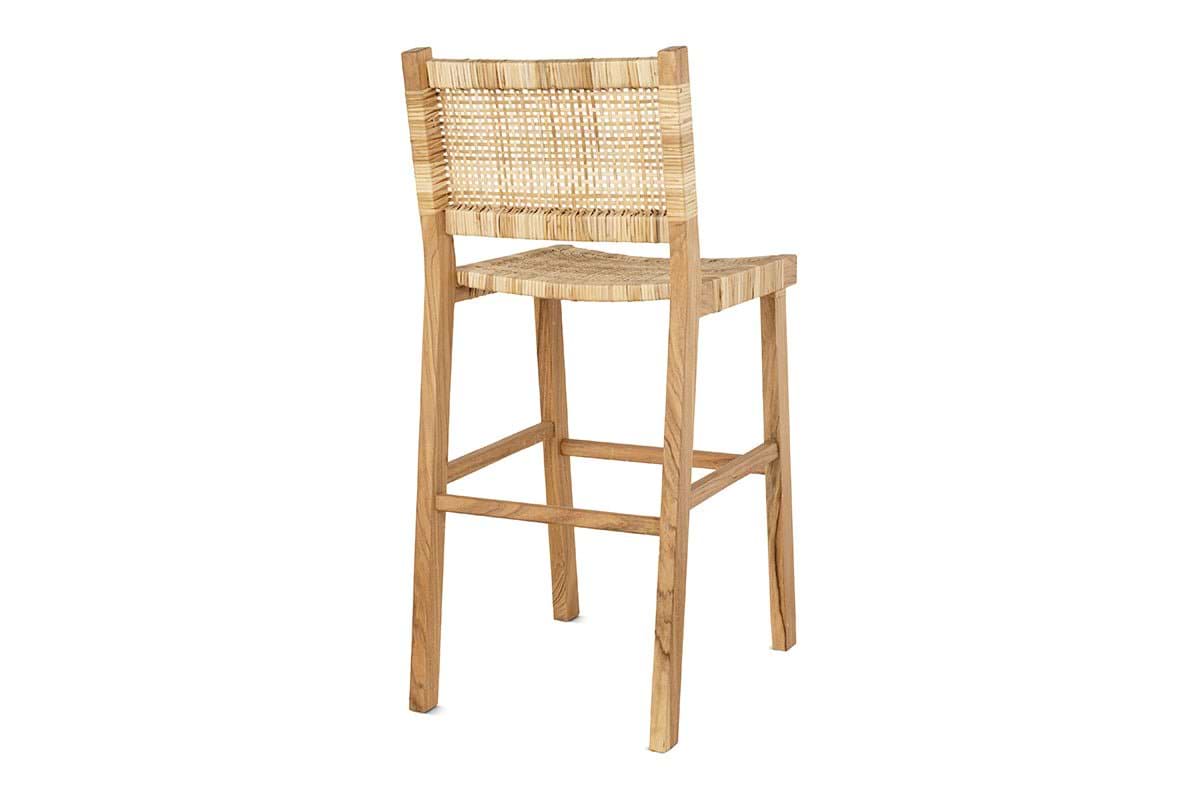 The Madrisana Acacia & Rattan Bar Stool by nkuku features a woven rattan backrest and seat, four straight legs in a natural wood finish, and a tight light-colored weave—combining sustainability and comfort with elegant design.