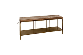 The nkuku Mahi Iron & Leather Bench features a slim brass frame, tanned leather cushion, and open lower shelf. Supported by four slender gold legs, its minimalist design and neutral palette bring modern style to any hallway.