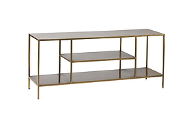 The nkuku Mahi Media Standing Shelf features a sleek, minimalist brass-finished metal frame and three open, dark-toned brass shelves—perfect for displaying entertainment equipment with modern style and open storage.