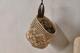The nkuku Mannu Cotton & Hemp Wall Hung Basket in Natural & Black features a slouched shape, thick stitching, and a dark loop for hanging—perfect for versatile storage or as an eye-catching decorative wall basket.