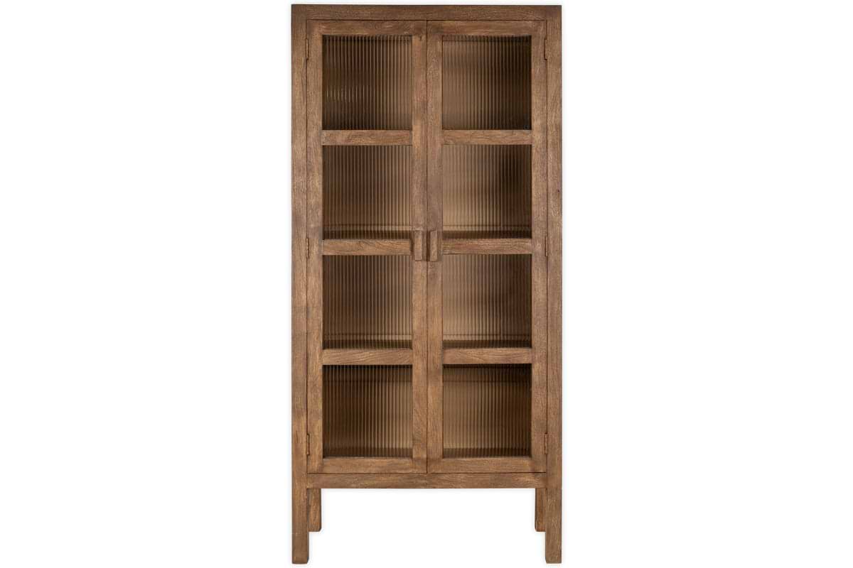 The Mendani Mango Wood & Fluted Glass Cabinet by nkuku features a tall, freestanding design in a walnut stain with two vertically grooved glass doors, simple rectangular lines, four short legs, and multiple shelves visible through the fluted panels.