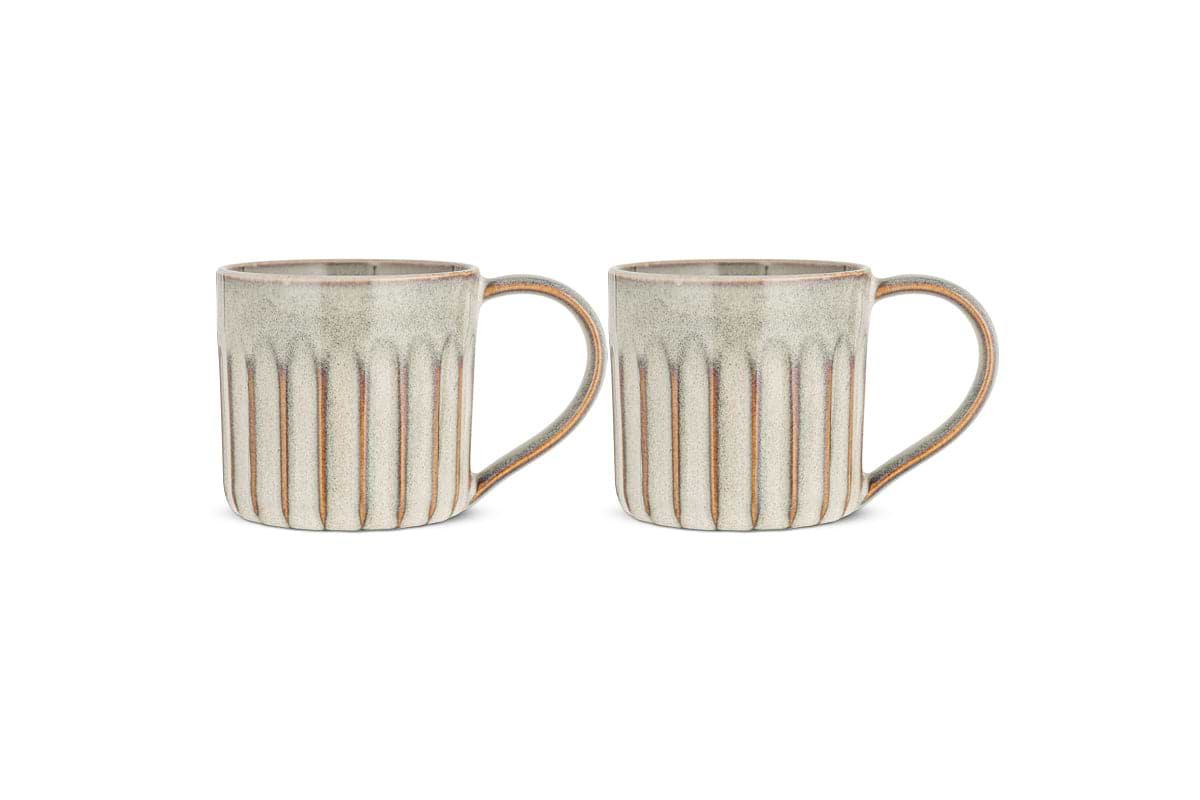 The Moda Mug - Natural (Set of 2) by nkuku features ceramic mugs with vertical ridges, a natural glaze in light grey and beige with brown accents, curved handles, and rounded rims—rustic drinkware on a white background.