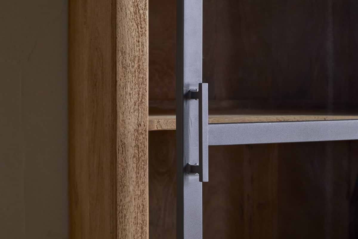 Close-up of nkukus Nirvi Mango Wood & Iron Tall Cabinet - Black, featuring a light mango wood frame, interior shelf, and a glass door with matte metal handle and black iron trim.