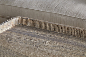 The Nisha Reclaimed Wood & Iron Coffee Table by nkuku features textured, grooved edges and a weathered, handcrafted look, bringing rustic charm and natural grain detail to any room.