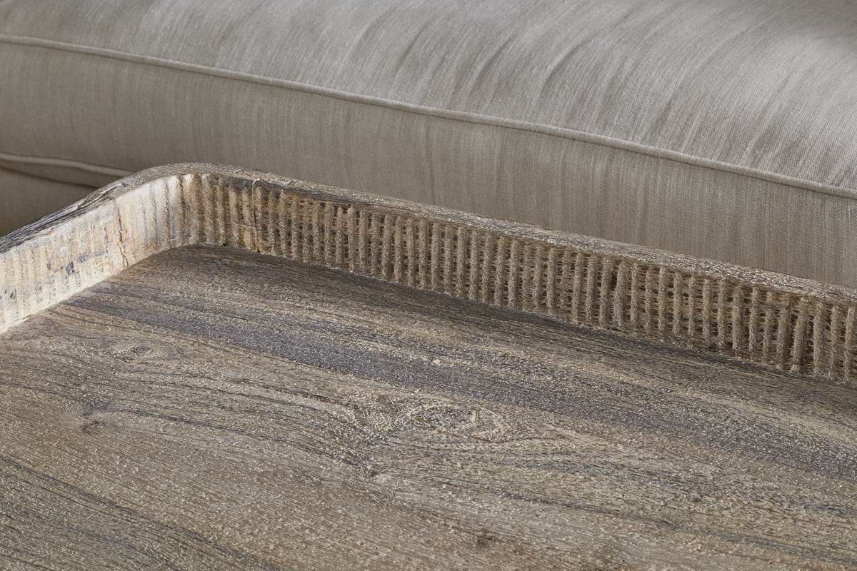 The Nisha Reclaimed Wood & Iron Coffee Table by nkuku features textured, grooved edges and a weathered, handcrafted look, bringing rustic charm and natural grain detail to any room.