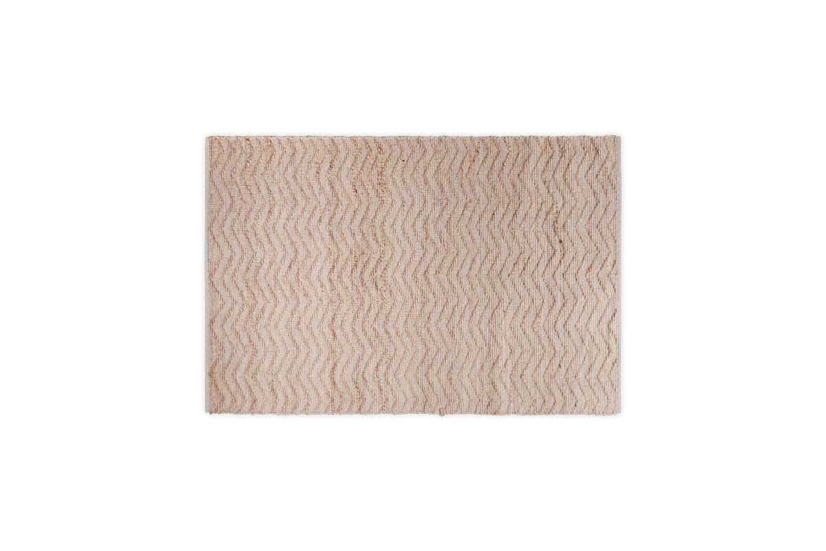 The Nabami Chevron Jute Rug - Natural by nkuku is a rectangular neutral rug with a subtle chevron pattern in darker beige, soft plush texture, and is centered on a plain white background.