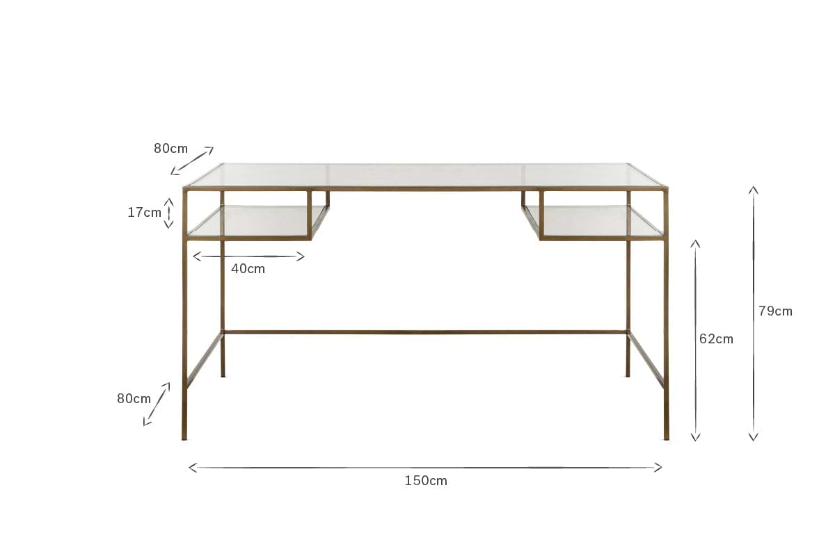 The Nakuru Iron & Glass Desk by nkuku features a modern glass top, slimline brass frame, and two shelf-like compartments. Ideal as stylish home office furniture. Dimensions: 150cm W x 79cm H x 80cm D with detailed shelving and leg measurements.