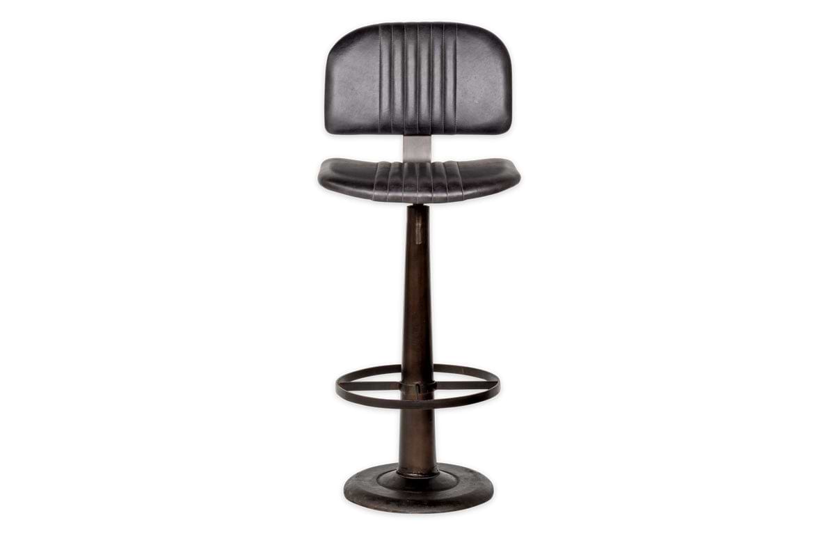 The Narwana Bar Chair - Aged Black by nkuku is a tall, black industrial-style stool with a ribbed leather padded backrest and seat, circular metal footrest, and round base—shown on a plain white background.