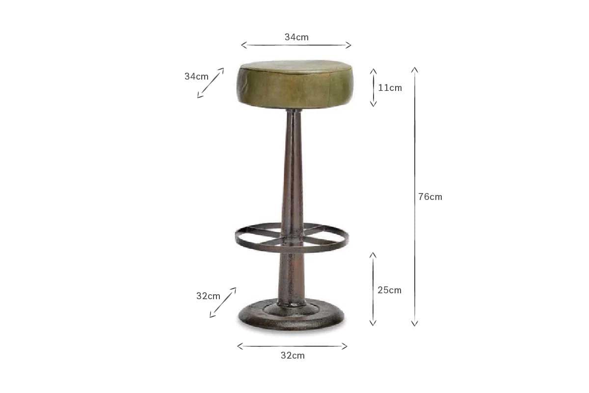 The Narwana Leather Round Stool - Rich Green by nkuku features a distressed green leather seat (34cm diameter, 11cm height), a metal stem with footrest, and a 32cm base; ideal bar stool for any kitchen island. Total height: 76cm.