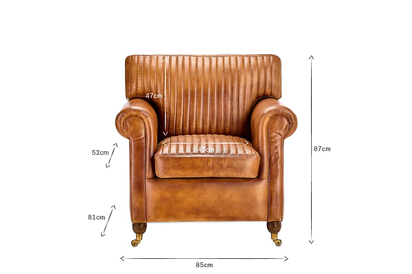 The nkuku Narwana Ribbed Leather Armchair - Aged Tan is a front-facing brown leather chair with ribbed stitching, small wheels on the legs, and measures 87x85x81cm (HWD); seat height 47cm, seat depth 49cm, armrest height 52cm.