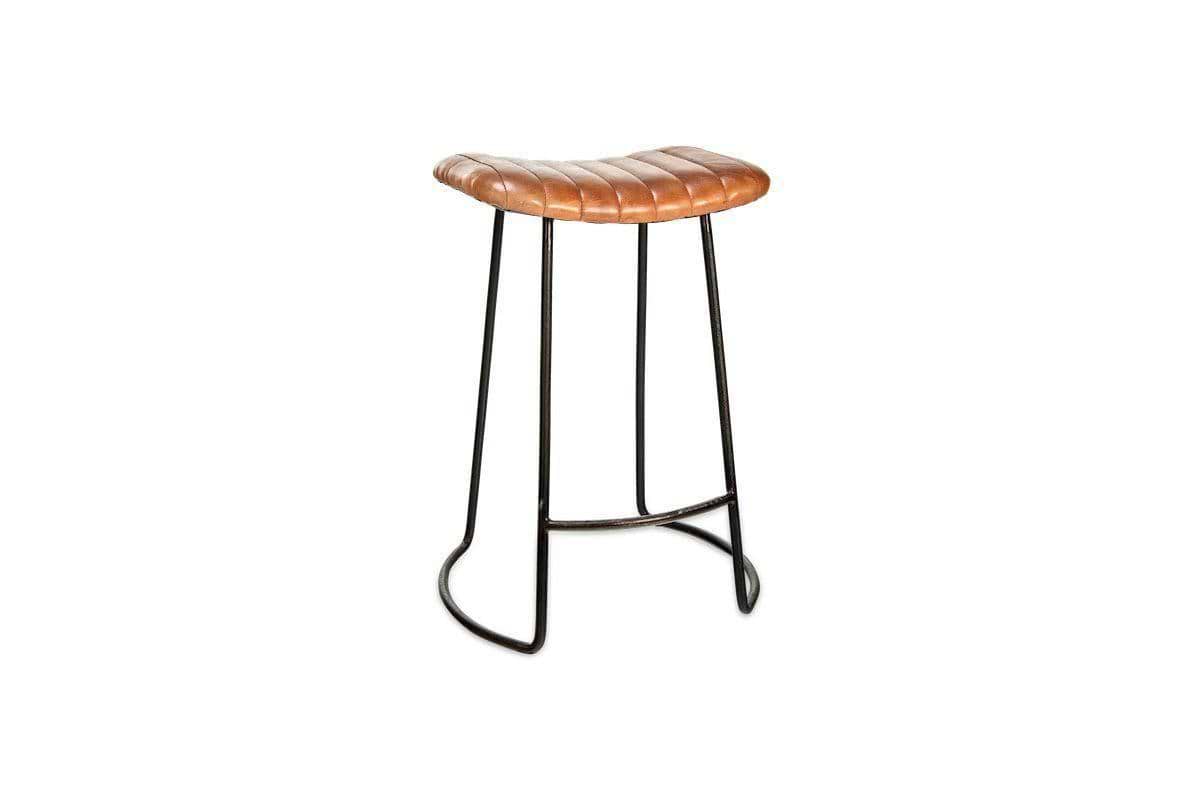 The nkuku Narwana Ribbed Leather Stool in Aged Tan (Small) features a padded tufted seat, distressed brown ribbed leather, and slim black metal legs, shown against a white background.
