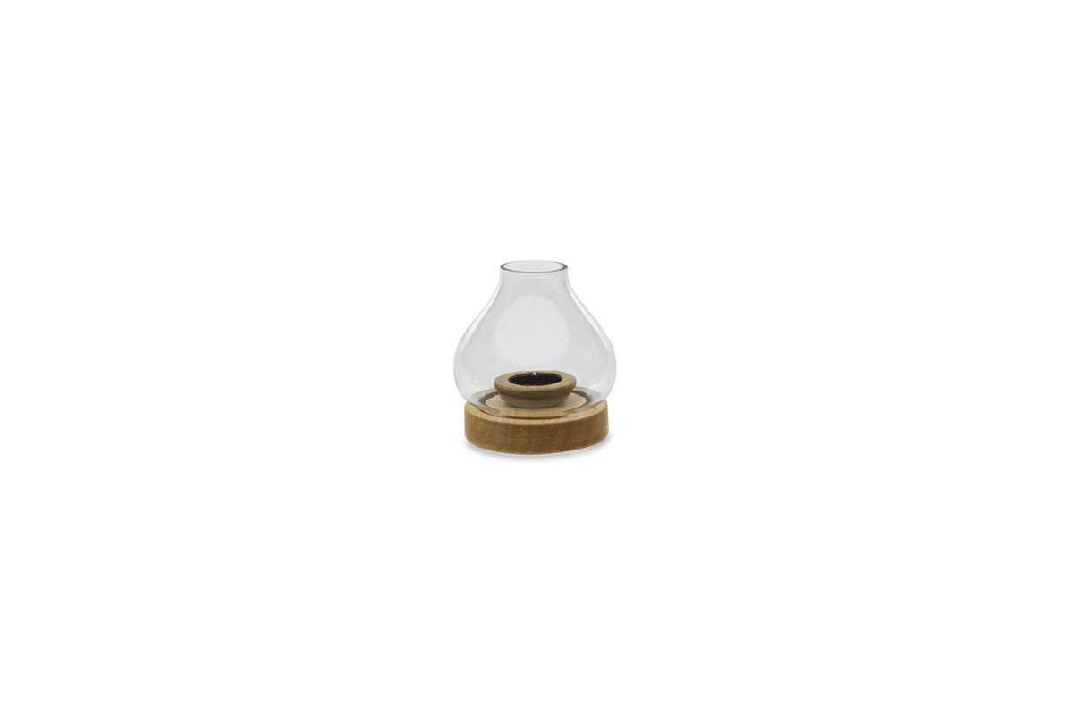 The nkuku Naryla Mango Wood Lantern - Natural features a small, modern design with a round mango wood base and clear, bulb-shaped recycled glass chimney, showcasing minimalism and natural wood texture.